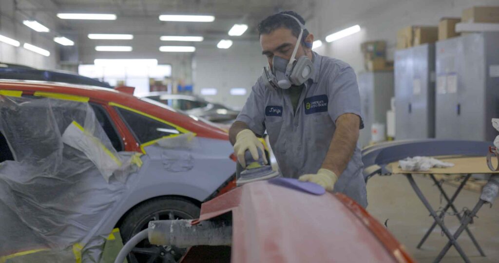 Technician sanding red bumper for paint – collision repair services – Zamora’s auto body rockville auto body shop Technician sanding red bumper for paint - collision repair services - Zamora's auto body rockville auto body shop